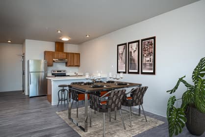 Staged kitchen and dining area at 459 Rock Apartments